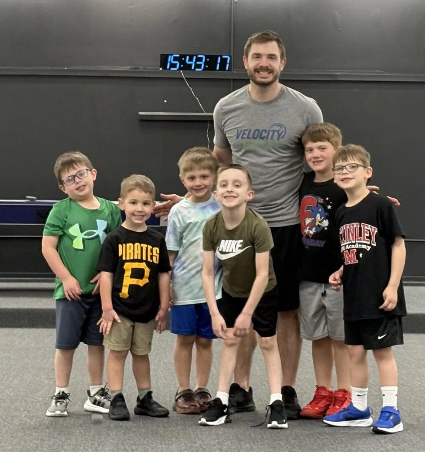 Coach with a group of young athletes after training
